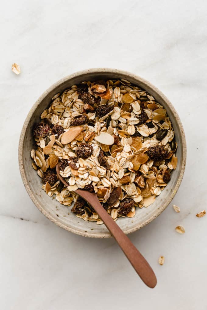 A bowl of muesli with a wooden spoon in it