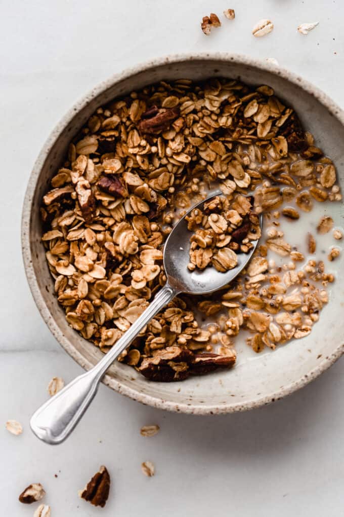 maple pecan granola in a bowl with a spoon